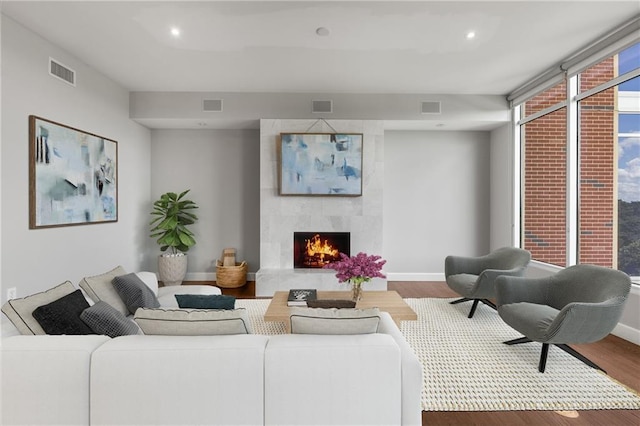 1820 Peachtree St NW Unit 804, Atlanta, GA 30309 - living area with wood finished floors, a large fireplace, and recessed lighting