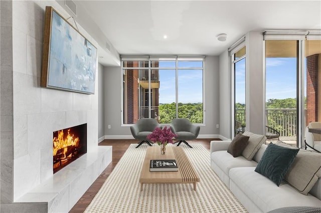1820 Peachtree St NW Unit 804, Atlanta, GA 30309 - living area with a premium fireplace, dark wood-type flooring, and a wall of windows