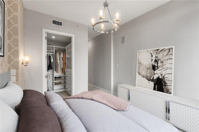 1820 Peachtree St NW Unit 804, Atlanta, GA 30309 - bedroom with radiator, a chandelier, a spacious closet, and a closet