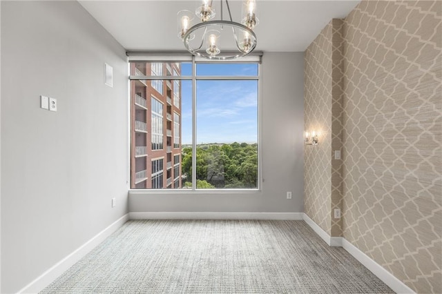 1820 Peachtree St NW Unit 804, Atlanta, GA 30309 - carpeted empty room featuring a chandelier and baseboards