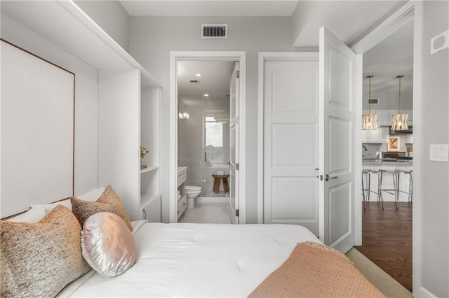 1820 Peachtree St NW Unit 804, Atlanta, GA 30309 - bedroom with wood finished floors, ensuite bath, and a chandelier