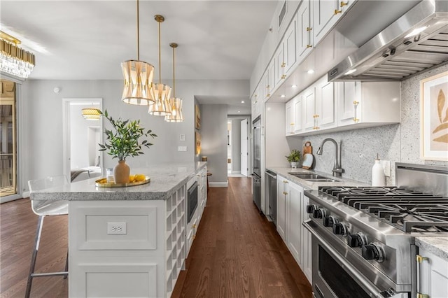 1820 Peachtree St NW Unit 804, Atlanta, GA 30309 - kitchen with ventilation hood, high quality appliances, white cabinetry, a kitchen island, and dark wood-type flooring