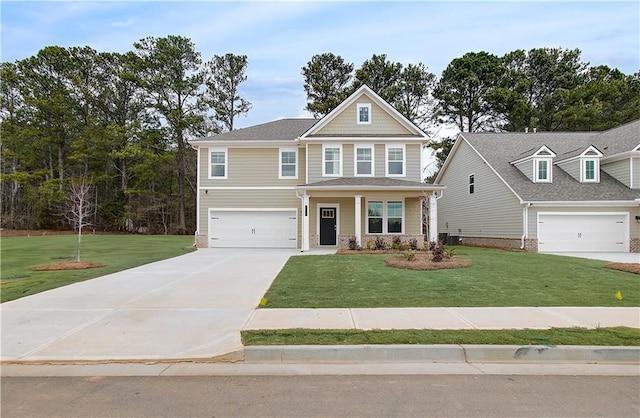 craftsman-style house featuring a garage, a front yard, and covered porch