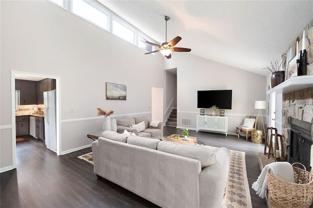 1140 Reading Dr NW, Acworth, GA 30102 - living room with high vaulted ceiling, stairway, ceiling fan, dark wood-style flooring, and a fireplace