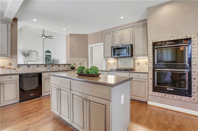 1215 Wynridge Xing, Alpharetta, GA 30005 - kitchen with black appliances, light wood-style flooring, a center island, decorative backsplash, and ceiling fan