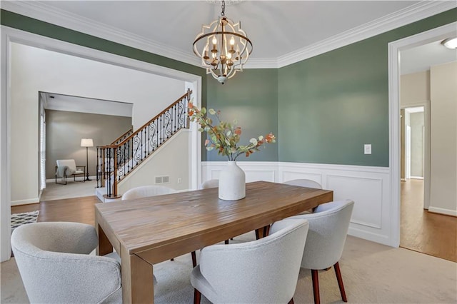 1215 Wynridge Xing, Alpharetta, GA 30005 - dining space featuring a chandelier, stairs, crown molding, and wainscoting