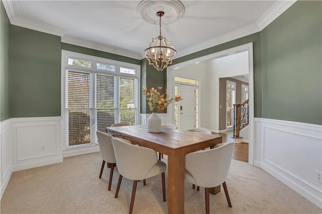 1215 Wynridge Xing, Alpharetta, GA 30005 - dining area featuring a chandelier, wainscoting, light colored carpet, ornamental molding, and a decorative wall