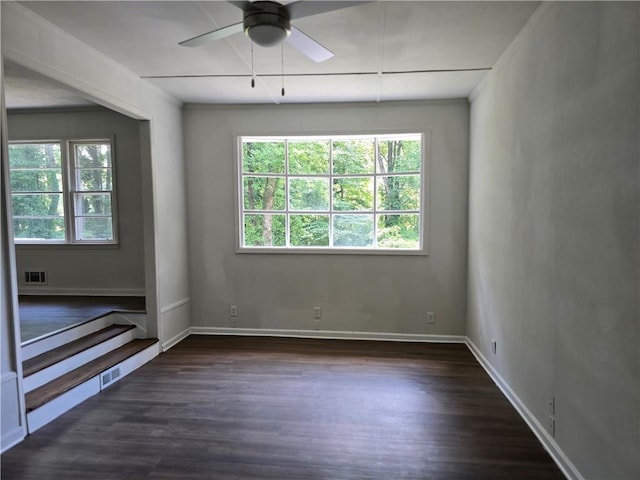 unfurnished room with dark wood-type flooring and ceiling fan