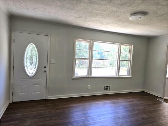 entryway featuring dark hardwood / wood-style floors and a textured ceiling