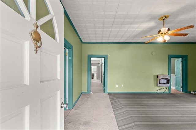 interior space featuring ceiling fan and heating unit