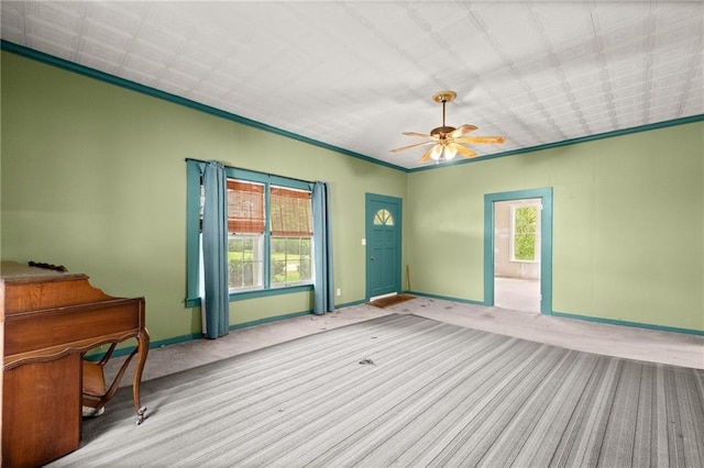 interior space featuring crown molding, ceiling fan, and a healthy amount of sunlight