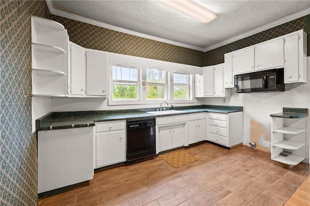 kitchen with crown molding, white cabinetry, sink, and black appliances