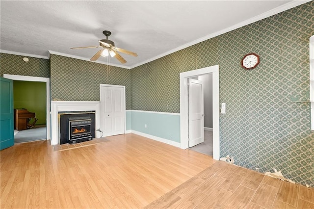 unfurnished living room featuring crown molding, hardwood / wood-style floors, and ceiling fan