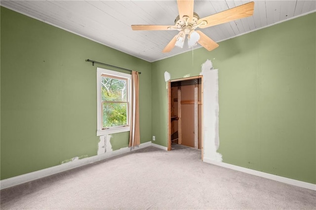 unfurnished bedroom with carpet flooring, ceiling fan, and a closet