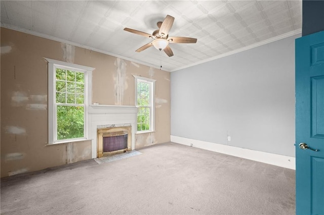 unfurnished living room with carpet floors, ceiling fan, and ornamental molding