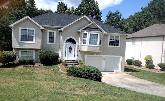 view of front of property with a front lawn and a garage