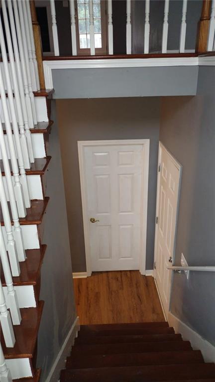 unfurnished room featuring a textured ceiling, ceiling fan, and wood-type flooring