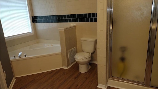 bathroom with plus walk in shower, toilet, and wood-type flooring