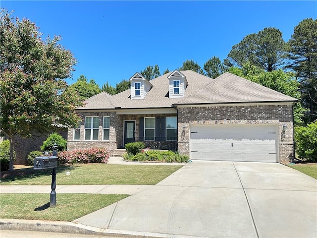 view of front of property with a front lawn and a garage