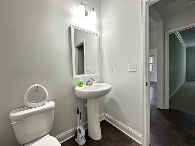 bathroom with wood-type flooring and toilet