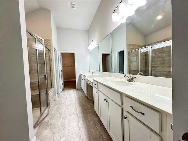 bathroom featuring vanity, an enclosed shower, and vaulted ceiling