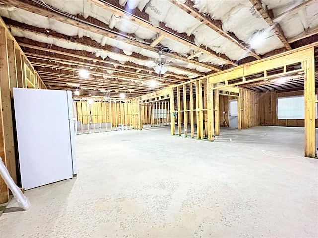 basement with white refrigerator