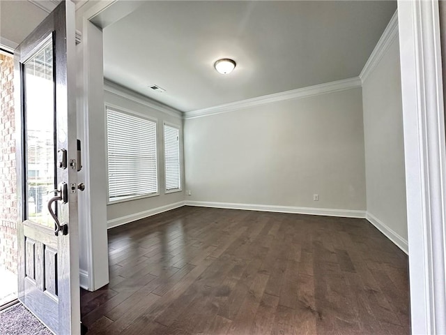 entrance foyer featuring ornamental molding, a wealth of natural light, and dark hardwood / wood-style floors