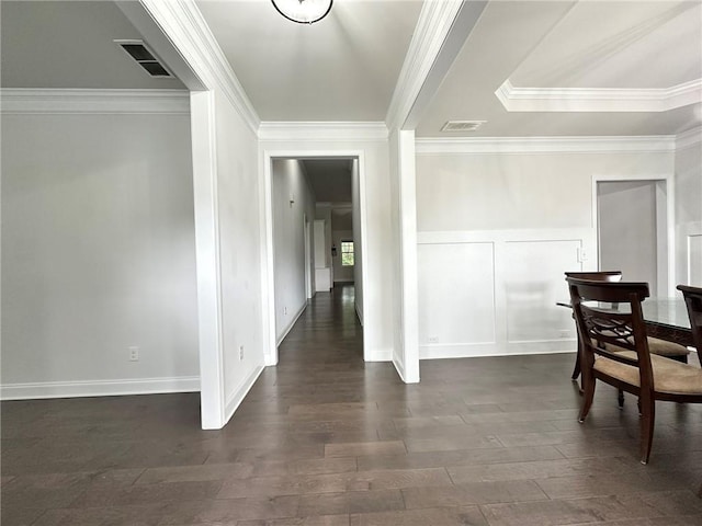 dining area featuring dark hardwood / wood-style flooring and ornamental molding