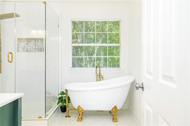 bathroom with a freestanding bath, a shower stall, and tile patterned flooring