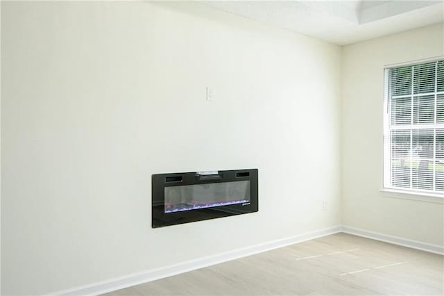 spare room featuring light wood-style flooring and baseboards