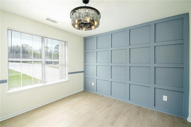 empty room featuring baseboards and light wood-type flooring