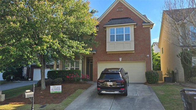 traditional home featuring an attached garage, driveway, brick siding, and central AC