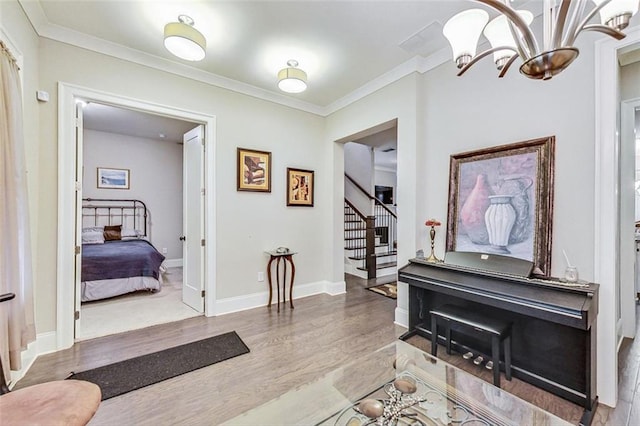 interior space featuring a chandelier, hardwood / wood-style floors, and crown molding