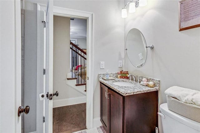 bathroom featuring hardwood / wood-style floors, vanity, and toilet