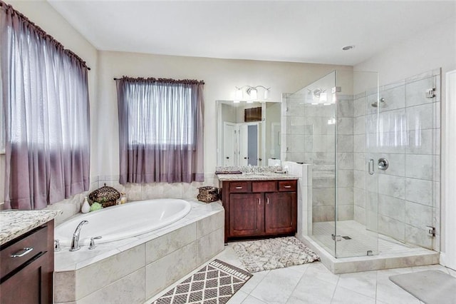 bathroom featuring vanity, separate shower and tub, and tile patterned floors