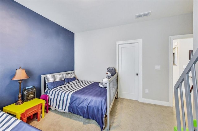 bedroom featuring light colored carpet