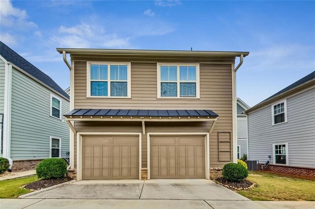 view of property with a front yard, a garage, and central AC