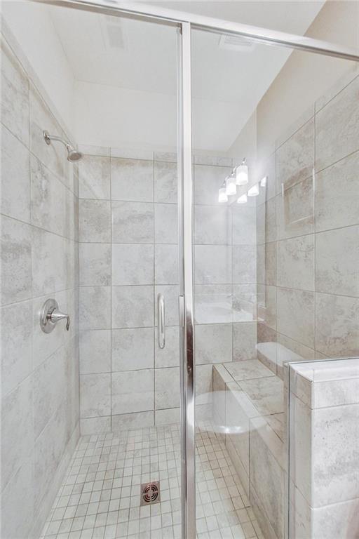 bathroom featuring a shower with door