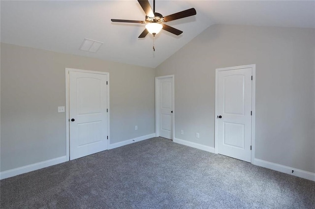 unfurnished room with ceiling fan, lofted ceiling, and dark carpet