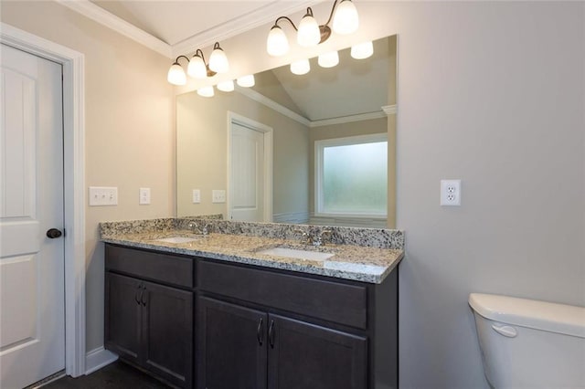 bathroom featuring vanity, crown molding, and toilet