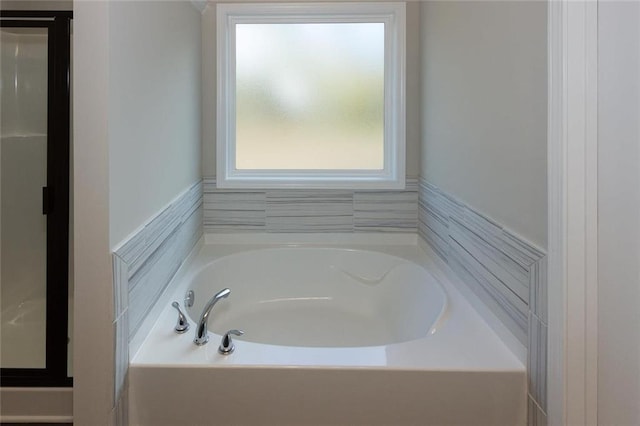 bathroom featuring a tub to relax in