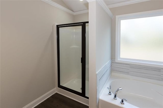 bathroom featuring hardwood / wood-style flooring, ornamental molding, and shower with separate bathtub