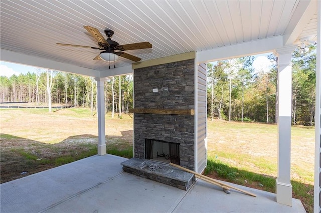 view of patio featuring ceiling fan and an outdoor stone fireplace