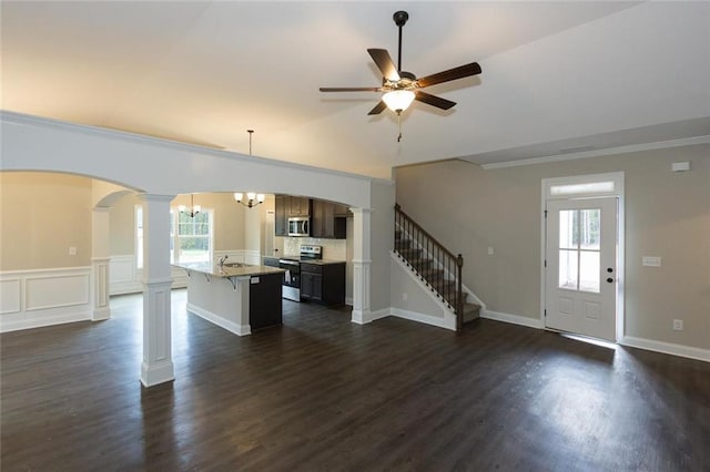 interior space with crown molding, dark hardwood / wood-style flooring, decorative columns, and a wealth of natural light