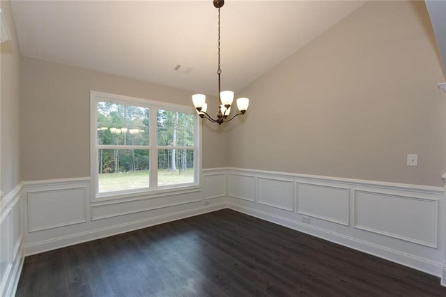 unfurnished room featuring lofted ceiling, dark hardwood / wood-style floors, and a notable chandelier