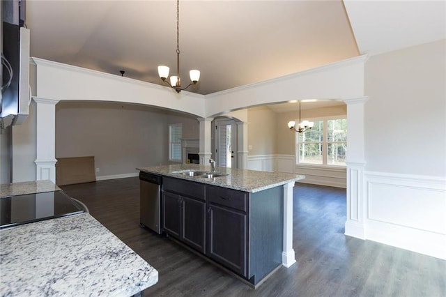 kitchen with sink, decorative light fixtures, stainless steel dishwasher, and a kitchen island with sink