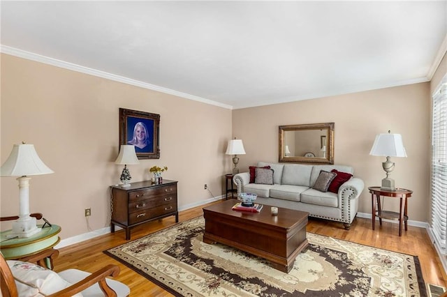 living area with ornamental molding, baseboards, and wood finished floors