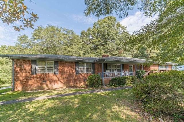 ranch-style home featuring a front yard, a porch, and brick siding