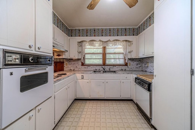 kitchen featuring light countertops, white appliances, white cabinetry, and a sink