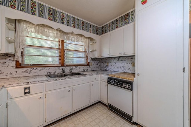 kitchen with white dishwasher, white cabinetry, and light countertops